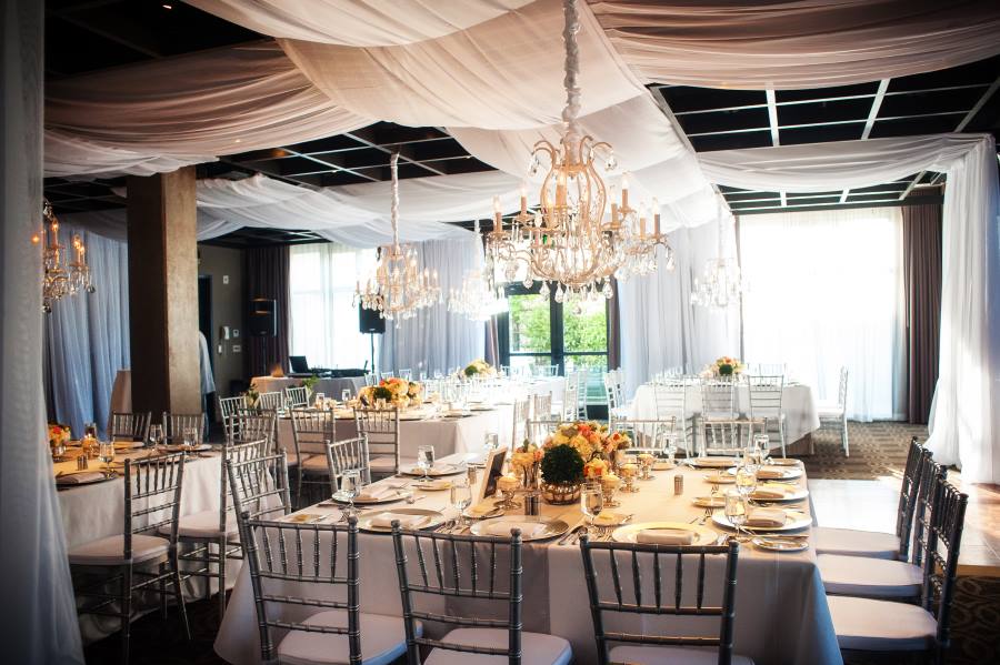 Revolution Reception with white drapes and linens and crystal chandeliers