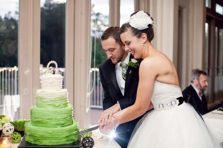 Proximity Hotel Wedding Katie and Chris Cutting Wedding Cake