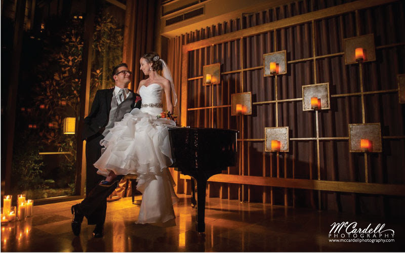 Proximity Hotel Wedding Theresa and Eric, bride and groom on piano