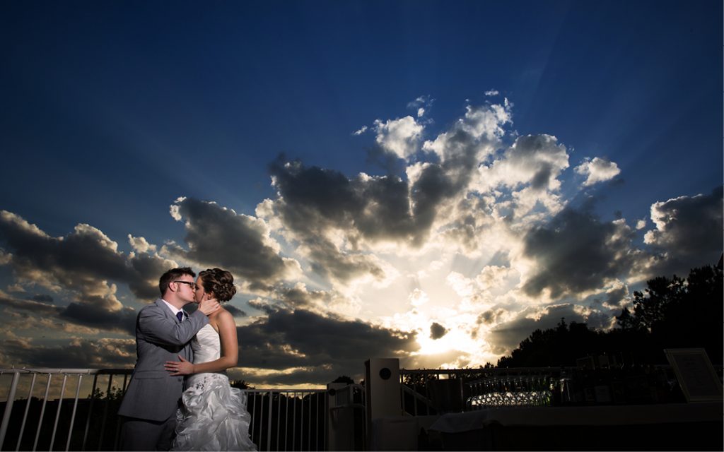 Proximity Hotel Wedding Katie and Sam, kissing at sunset