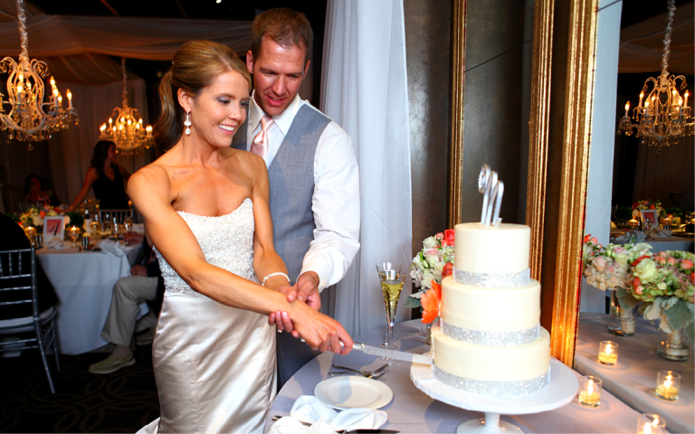 Proximity Hotel Wedding, Whitney and Dustin, cutting the cake