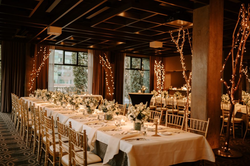 Jordan Vines | Vines Studios Wedding dinner event set with two Bacchanals, Chiavari Chairs with House Linens, green and white florals. Bistro tables in between bacchanals.