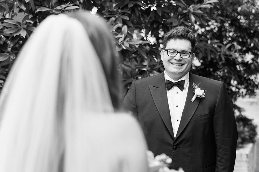 Bride and groom sharing a first look in the Bluebell Garden at Proximity Hotel in Greensboro, North Carolina