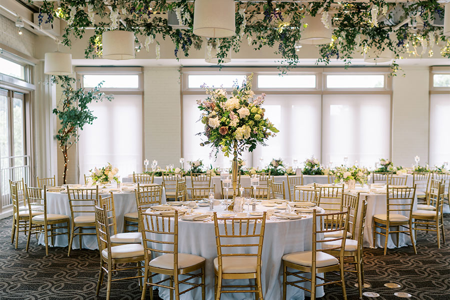 Wedding reception in the Weaver Room at Proximity Hotel featuring a live band, custom dance floor, and floral design