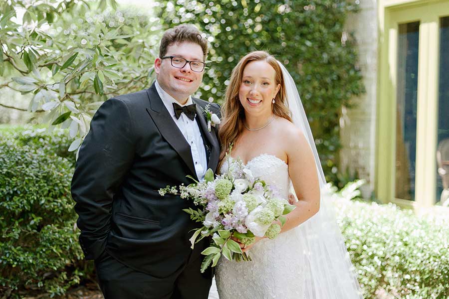 Bride and Groom posing in the bluebell garden