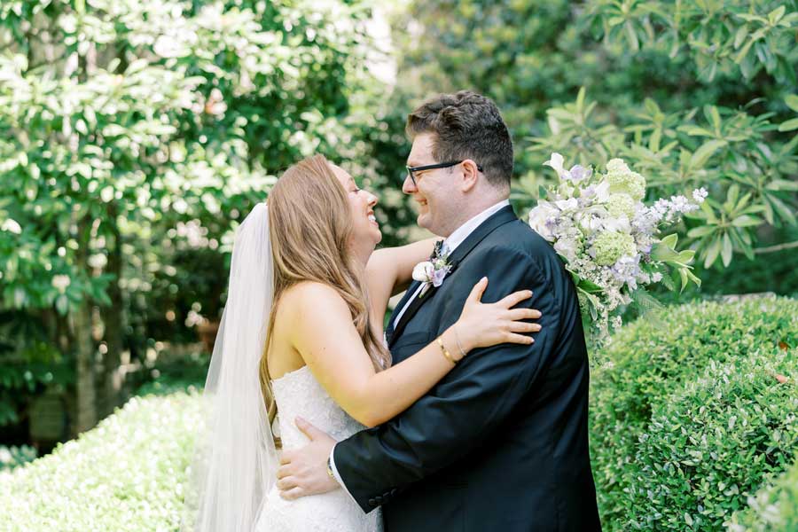 The Bride and Groom gaze at each other in the Bluebell Garden