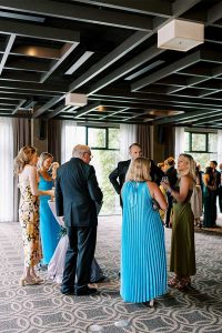 Guests wait as the bride and groom take photos.