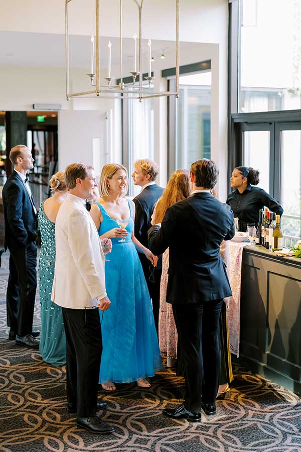 Guests stand in line and socialize in the weaver breezeway bar area.